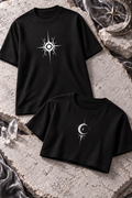 A black tee with a white sun graphic beside a black cropped top with a white crescent and star.