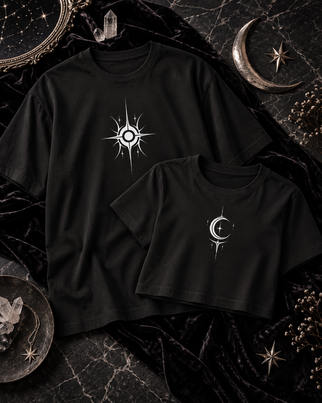 A black tee with a white sun graphic beside a black cropped top with a white crescent and star.